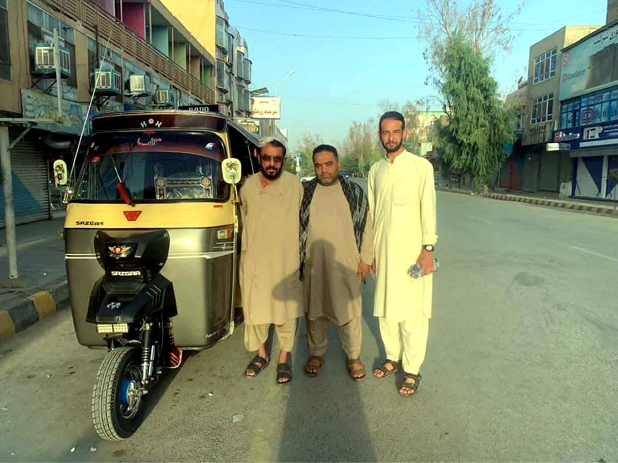 Local guides beside a rickshaw on a Kabul street